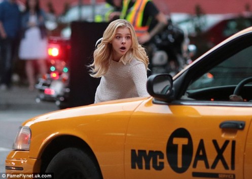 Chloe Grace Moretz as Susannah Cahalan pretends to evade collision with a cab, in Brain on Fire.
