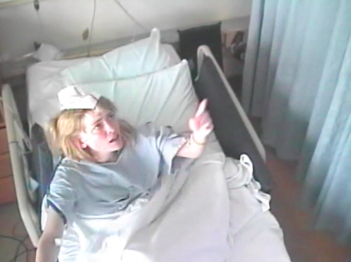An image of the real Susannah Cahalan experiencing a hallucination in the hospital, from closed circuit video of her hospital room. This image was distributed in combination with publicity for Cahalan's book.